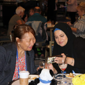 Photograph of OLC Accelerate attendee sharing something with another attendee
